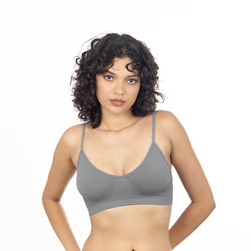 Woman wearing a gray bra on a white background